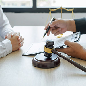 California business partner breakup legal advice with judges gavel standing in front of the male lawyer is providing service.