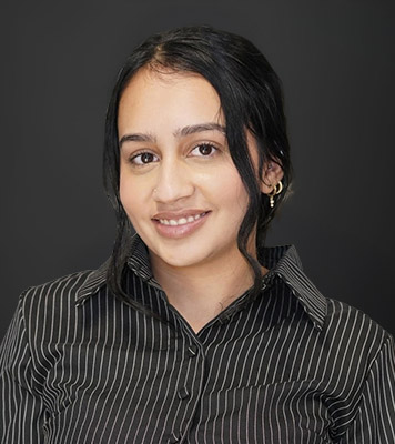 Headshot of Namanpreet Kaur, Intern, with dark hair and a striped shirt.