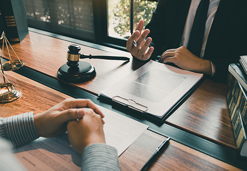 Lawyer and client discussing legal contract for a business sale in Mountain House, CA.